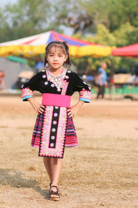 Portrait of a girl standing on field