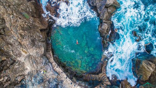 High angle view of rocks by sea