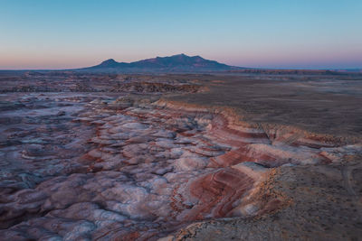 Dramatic moonscape landscape in utah. red rocks slow at sunrise. striped layered rock formations.