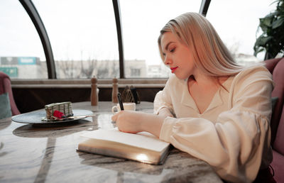 Woman sitting on table at restaurant