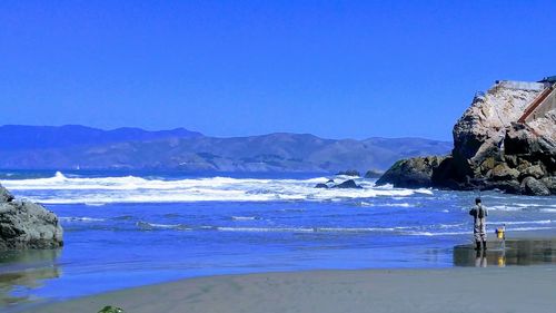 Scenic view of sea against clear blue sky