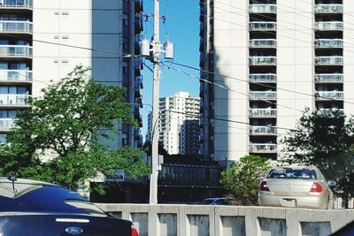 Cars in city against sky