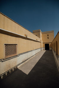 Low angle view of building against clear blue sky