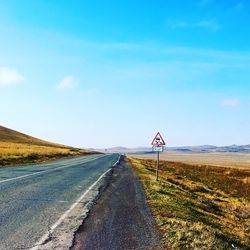 Empty road by landscape 