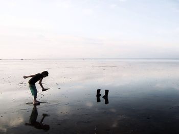 People standing on sea shore