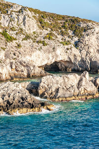 Scenic view of sea against rock formation