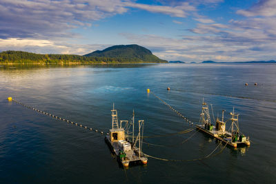 Boats moored in sea against sky