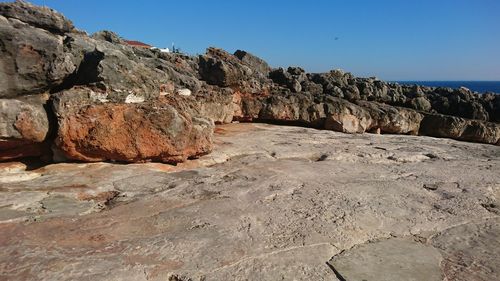 Rock formations against clear blue sky