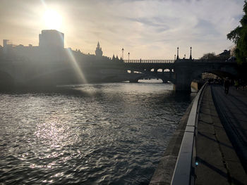 View of bridge over river against cloudy sky