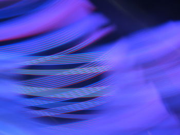 Close-up of light painting against blue background