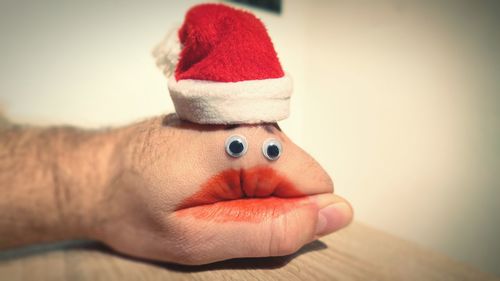 Close-up of hand puppet wearing santa hat on table