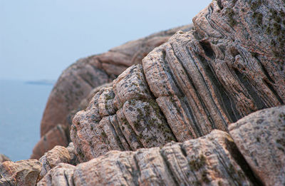 Close-up of rocks on shore against sky