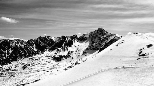 Scenic view of snow covered mountains against sky