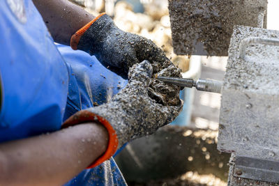 Midsection of man working in workshop