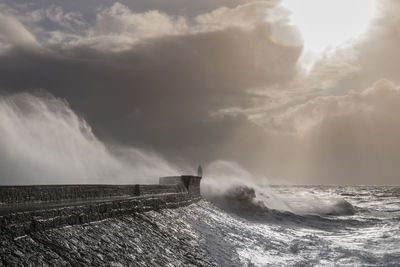 Scenic view of sea against storm clouds