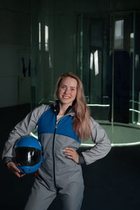 Portrait of smiling young woman standing in court