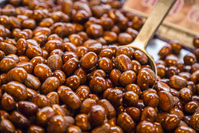 Close-up of roasted hazelnuts and spoon