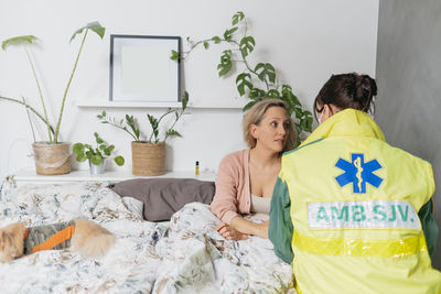 Doctor examining patient at home