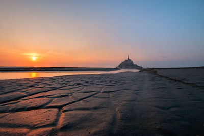 View of mont saint-michel and river against sky during sunset