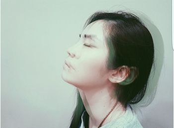 Close-up of young woman over white background
