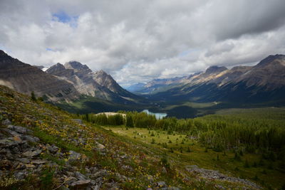 Scenic view of mountain range against cloudy sky