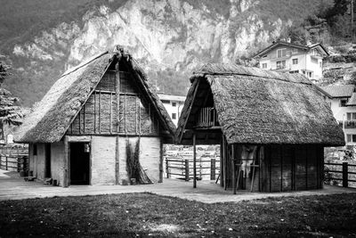 Old house amidst trees and buildings