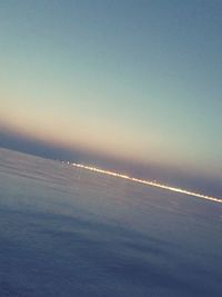 Scenic view of sea against clear sky at sunset