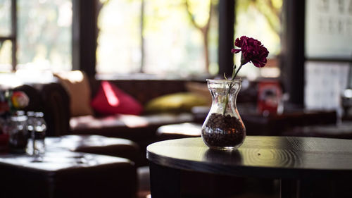 Close-up of glass vase on table in restaurant
