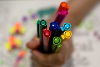 Close-up of hand holding multi colored candies