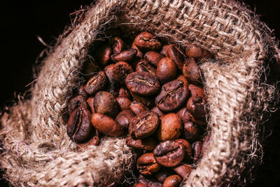 High angle view of roasted coffee beans in sack