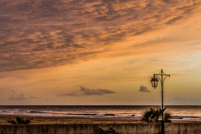 Scenic view of sea against orange sky