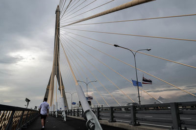 Man on bridge against sky