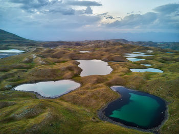 Scenic view of landscape against cloudy sky