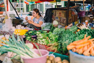 Female vendor having lunch in vegetable market