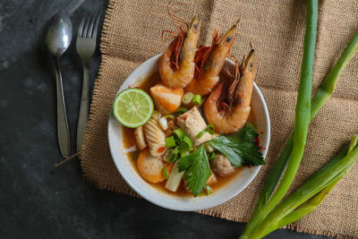 Tom yam soup originating from thailand. tom yum is made with shrimp, chili, lime, chicken, fish, 