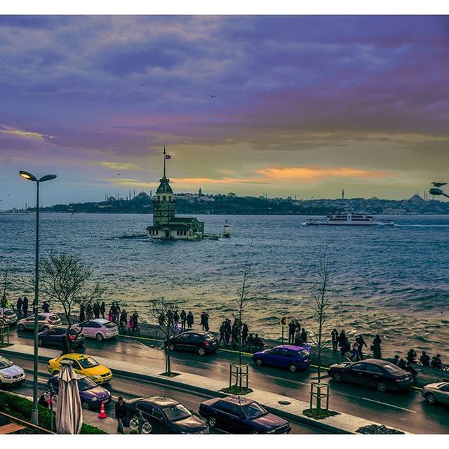 sky, cloud - sky, sea, water, large group of people, built structure, transportation, sunset, architecture, cloudy, mode of transport, building exterior, nautical vessel, travel, tourism, travel destinations, cloud, city, outdoors