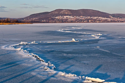 Scenic view of sea against sky during winter