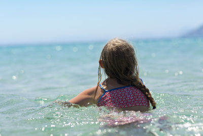 Girl swimming in sea, greece