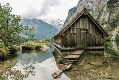 House against mountains during foggy weather