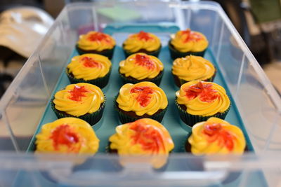 Close-up of cupcakes in container on table