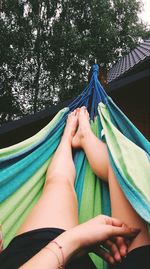 Low section of woman relaxing on hammock