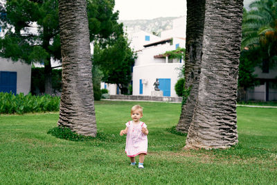 Full length of girl on tree trunk