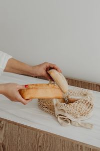 Cropped hand of person preparing food on table