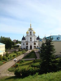 Church by building against sky