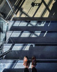 Low section of man standing on staircase