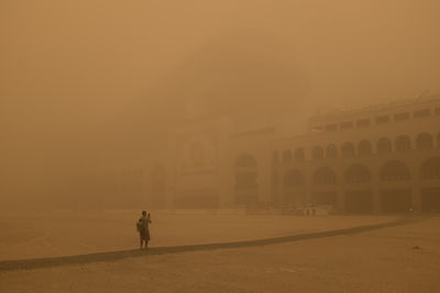 People walking in front of building