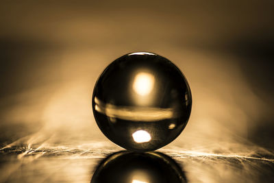 Close-up of crystal ball on metal