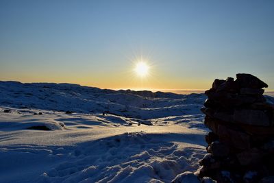 Scenic view of snow against sky during sunset