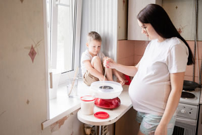 High angle view of mother preparing food at home