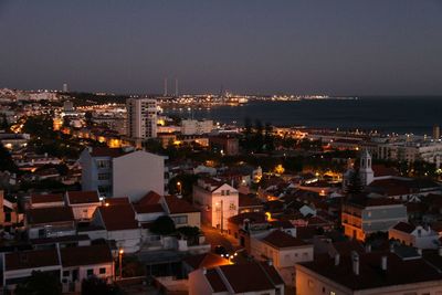 High angle view of illuminated cityscape against sky at night